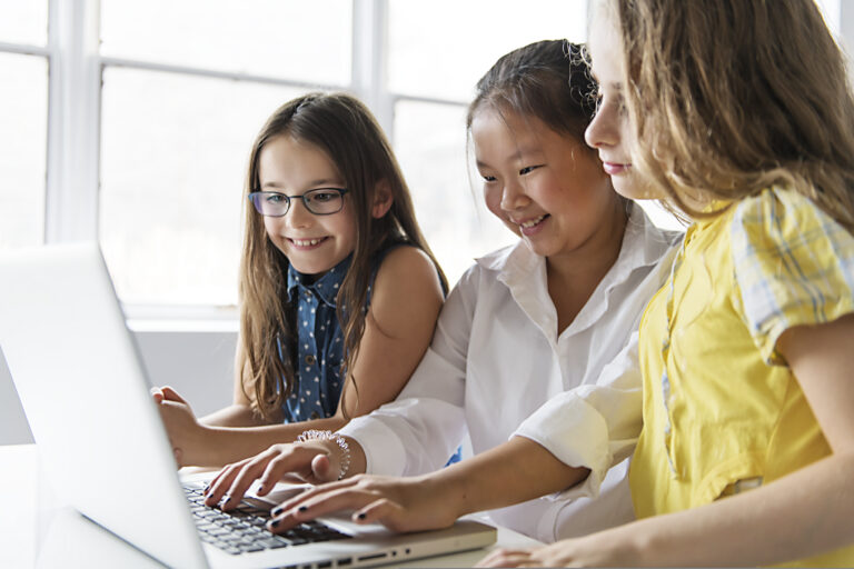 Group of curious children watching and learning on a laptop