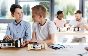 Boys building robot together at Love to Code Academy