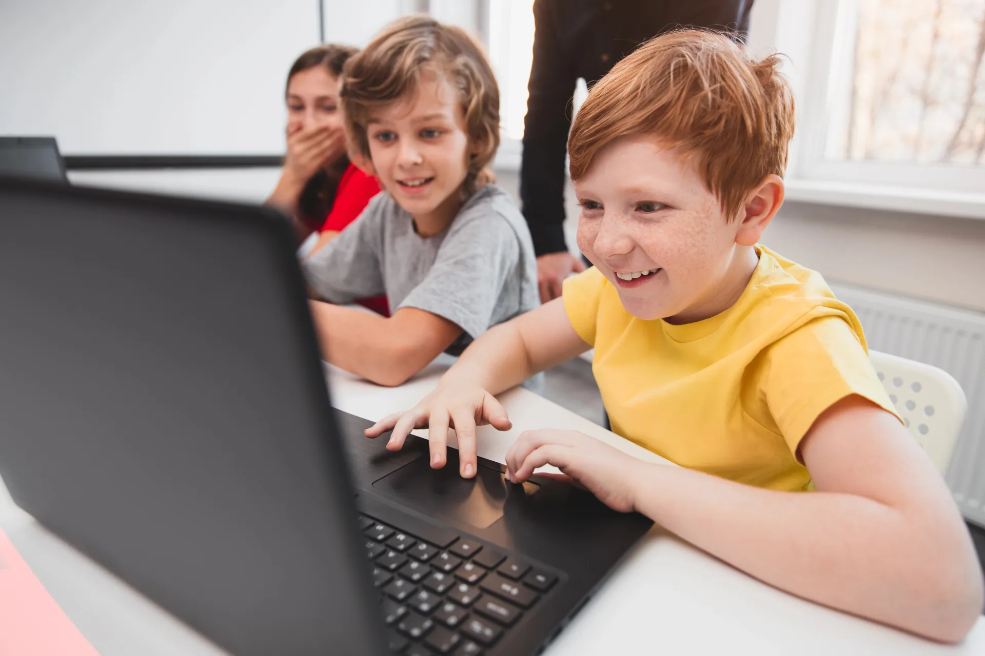 Boys excited laptop coding at Love to Code Academy