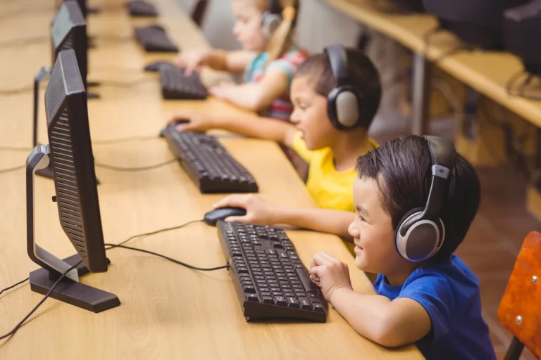 Students headphones computer lab at Love to Code Academy