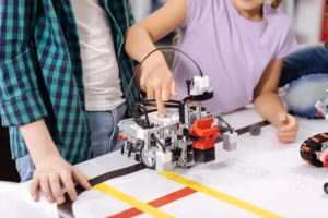 Students programming robot on track at Love to Code Academy