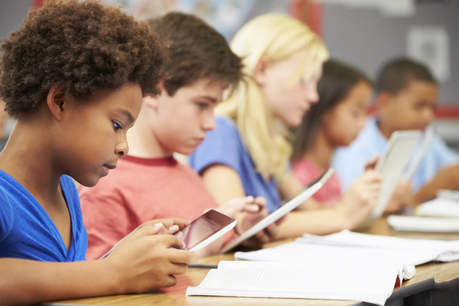 Students tablets classroom row at Love to Code Academy