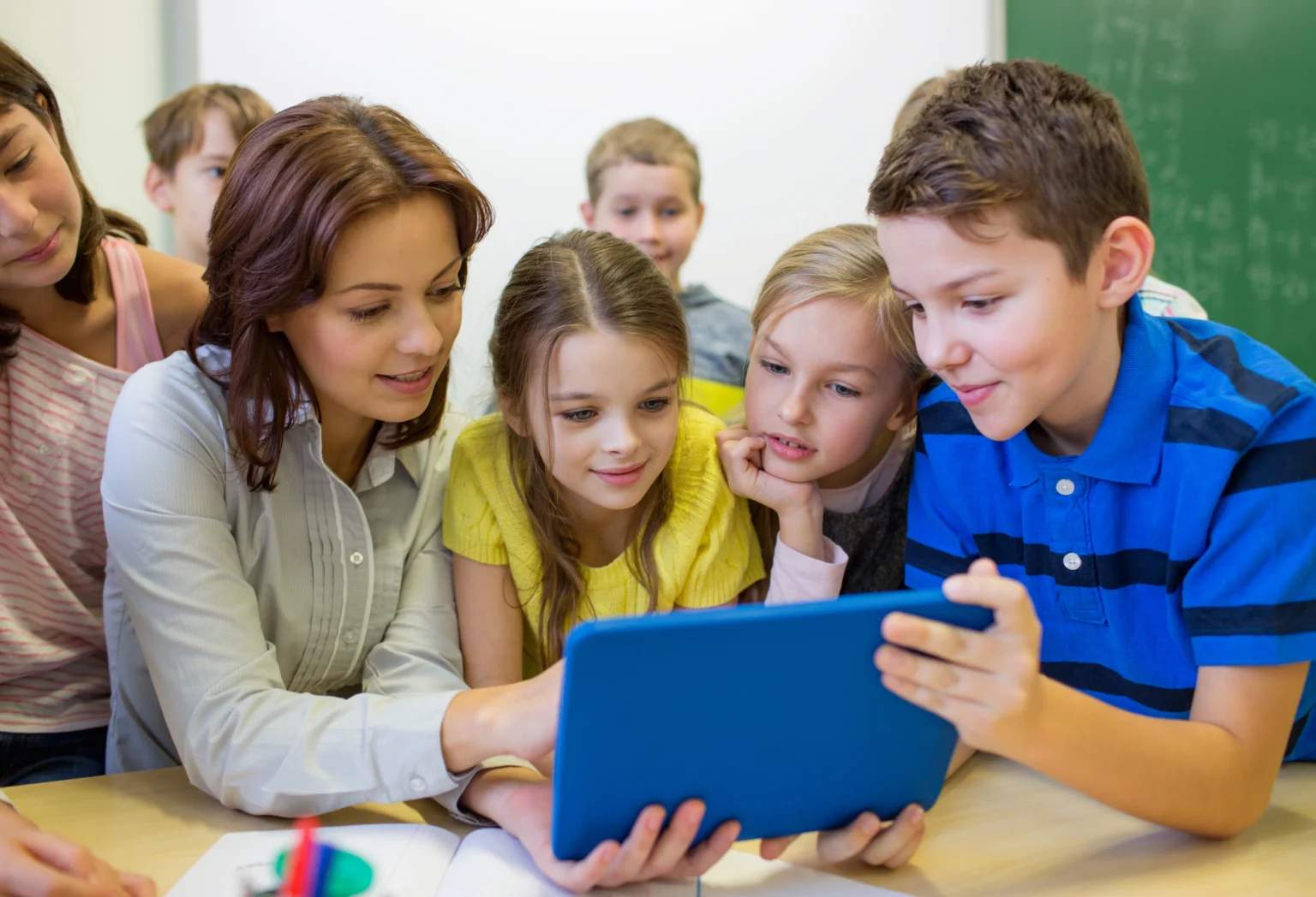 Instructor students sharing tablet at Love to Code Academy