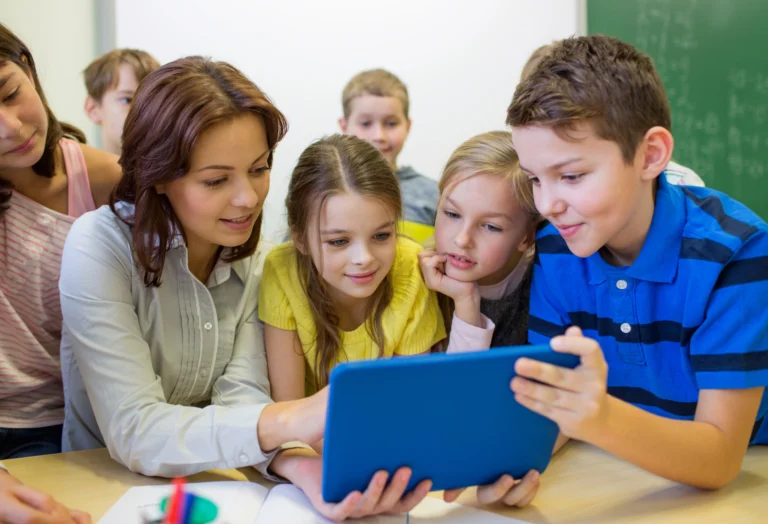 Instructor students sharing tablet at Love to Code Academy